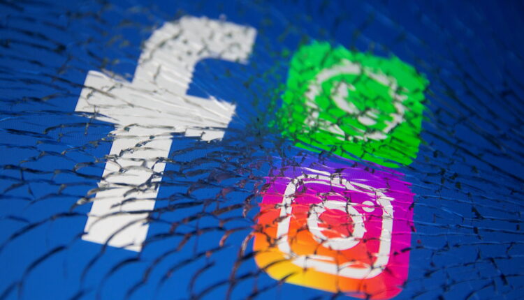 Facebook, Whatsapp and Instagram logos are displayed through broken glass in this illustration